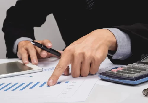 business-people-discussing-financial-charts-closeup-shot-hands-table